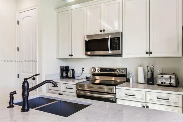 a view of cabinets and stainless steel appliances