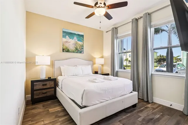 a bedroom with a bed chandelier and a window