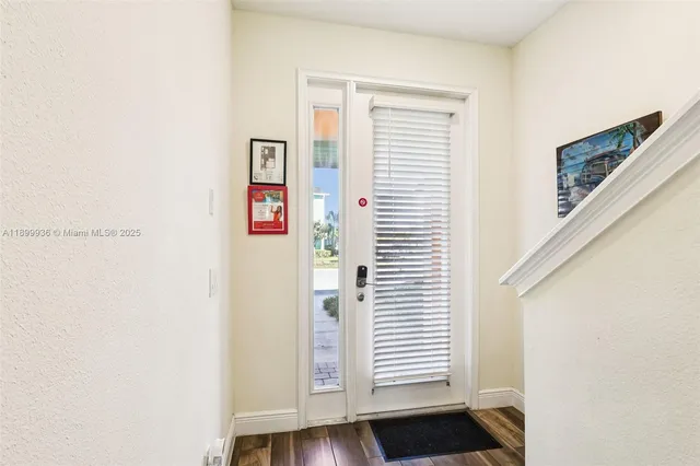 a view of an entryway with wooden floor
