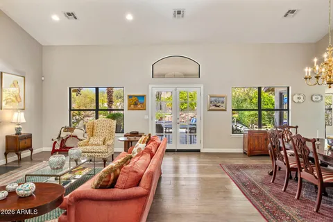 a living room with furniture fireplace and a large window