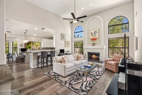 a living room with fireplace furniture and a large window