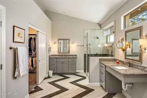 a bathroom with a granite countertop sink mirror and shower