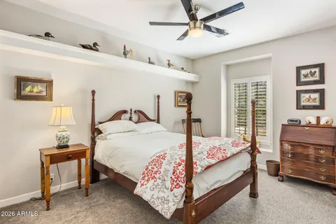 a bedroom with a bed and a tv