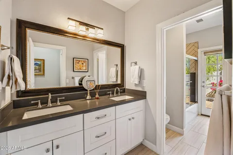 a en suite bathroom with double sink and a mirror