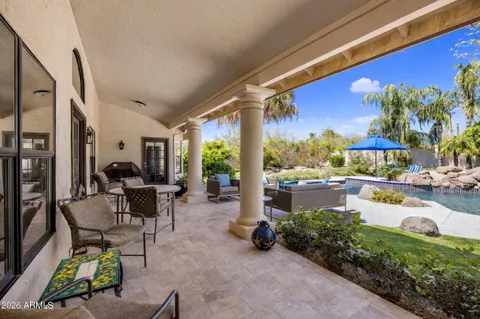 a view of a chairs and table in a patio