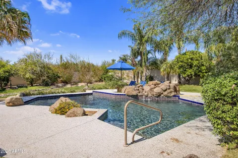a view of a swimming pool and lounge chairs