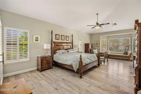 a bedroom with a large bed and a window