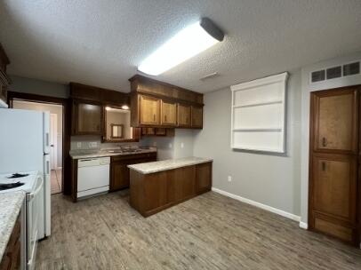 2318 18th Street Lubbock, TX 79401 - Photo 13 of 21 a kitchen with a refrigerator and a stove top oven