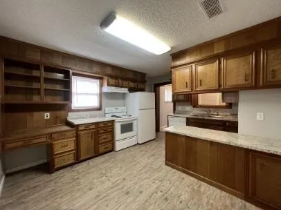 a kitchen with a sink stove and cabinets