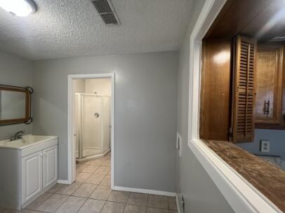 2318 18th Street Lubbock, TX 79401 - Photo 18 of 21 a bathroom with a sink a toilet and mirror