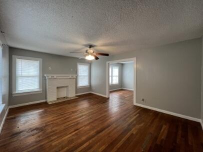 2318 18th Street Lubbock, TX 79401 - Photo 6 of 21 a view of an empty room with wooden floor and a window