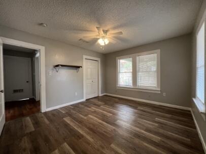2318 18th Street Lubbock, TX 79401 - Photo 8 of 21 a view of empty room with wooden floor and fan