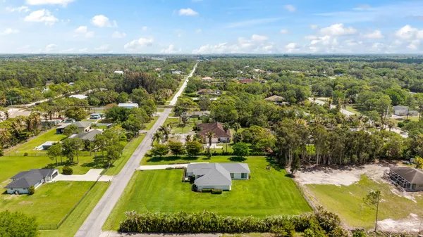 an aerial view of residential houses with outdoor space and river