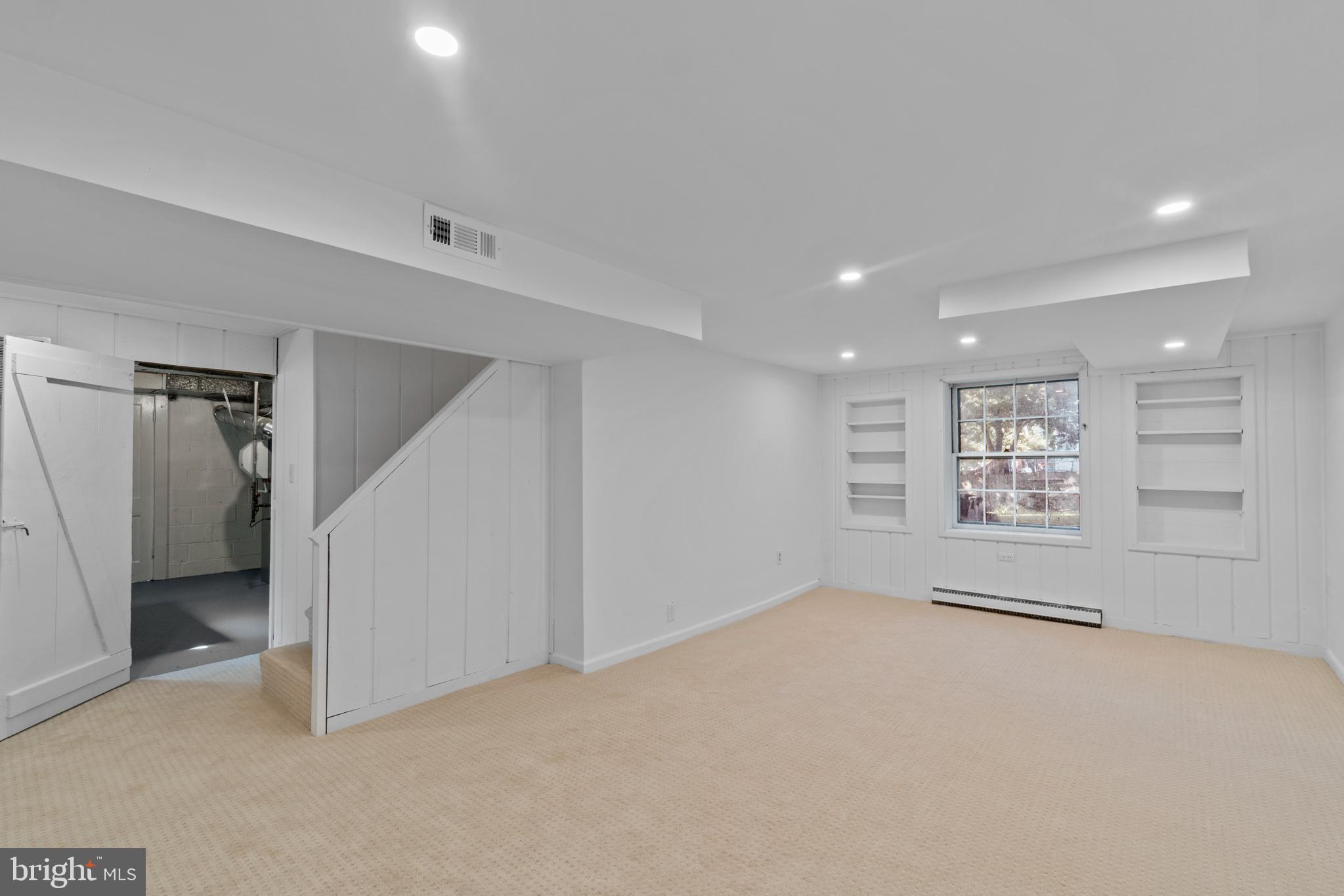 9002 Walden Road Silver Spring, MD 20901 - Photo 18 of 23 Lower level rec room with built-in shelving.