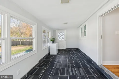 a kitchen with white cabinets stainless steel appliances and a window