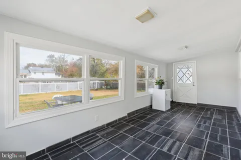 a kitchen with stainless steel appliances granite countertop a refrigerator a sink a stove and white cabinets