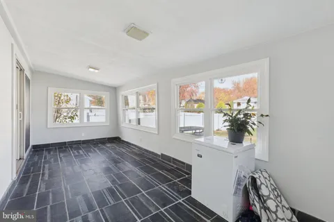 a living room with furniture a dining table and wooden floor