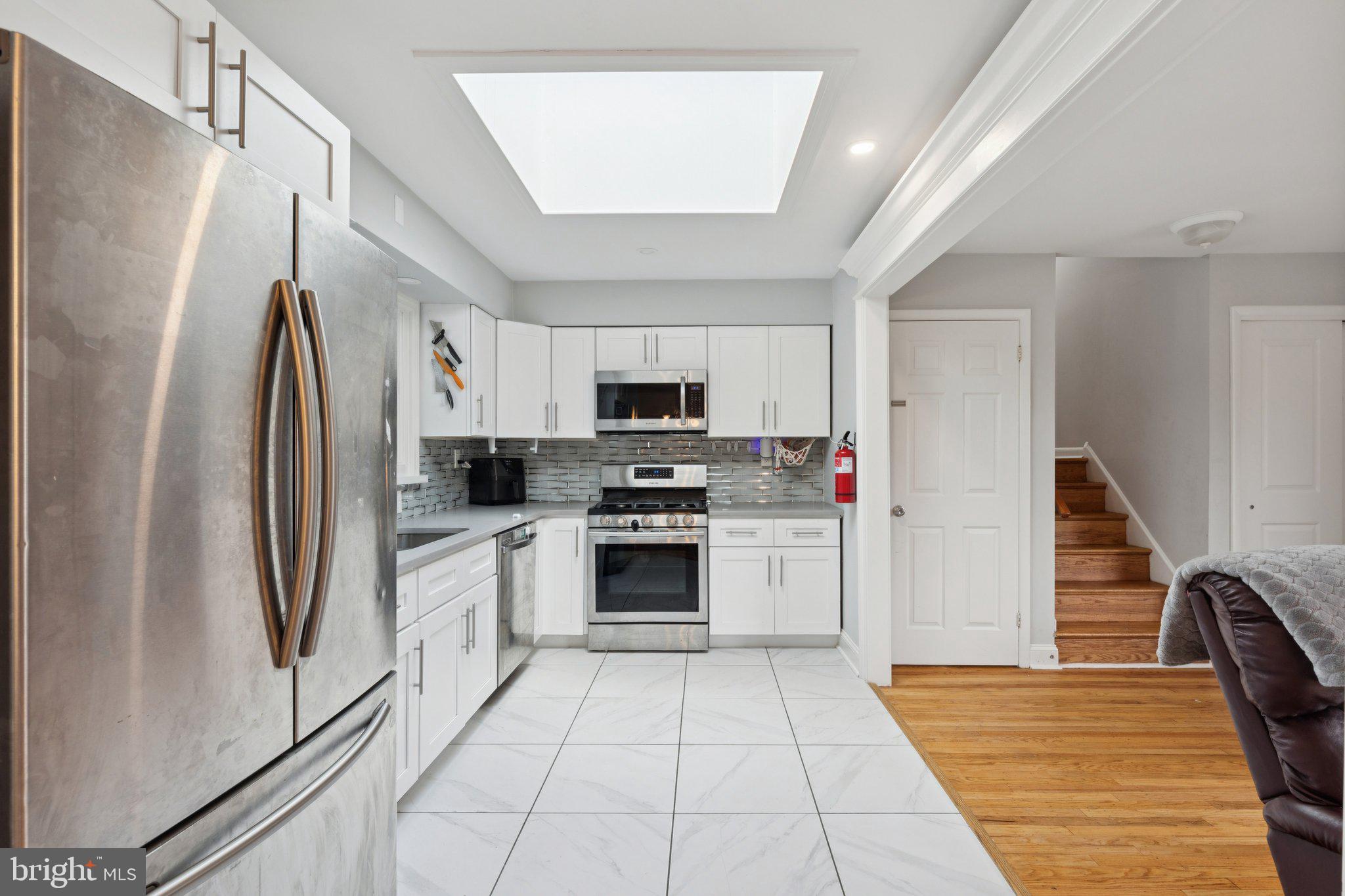 407 Yorkshire Road Cherry Hill, NJ 08034 - Photo 19 of 62 a kitchen with stainless steel appliances a refrigerator sink and microwave