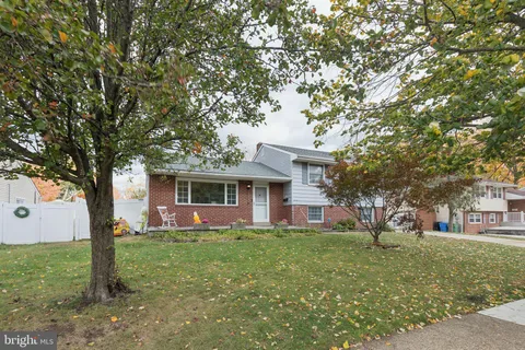 a front view of house with a garden