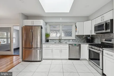 a view of a workspace with furniture and wooden floor
