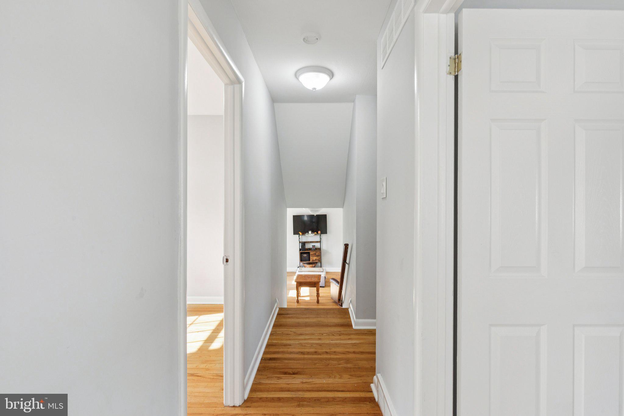 407 Yorkshire Road Cherry Hill, NJ 08034 - Photo 30 of 62 a view of a hallway with wooden floor and a bathroom