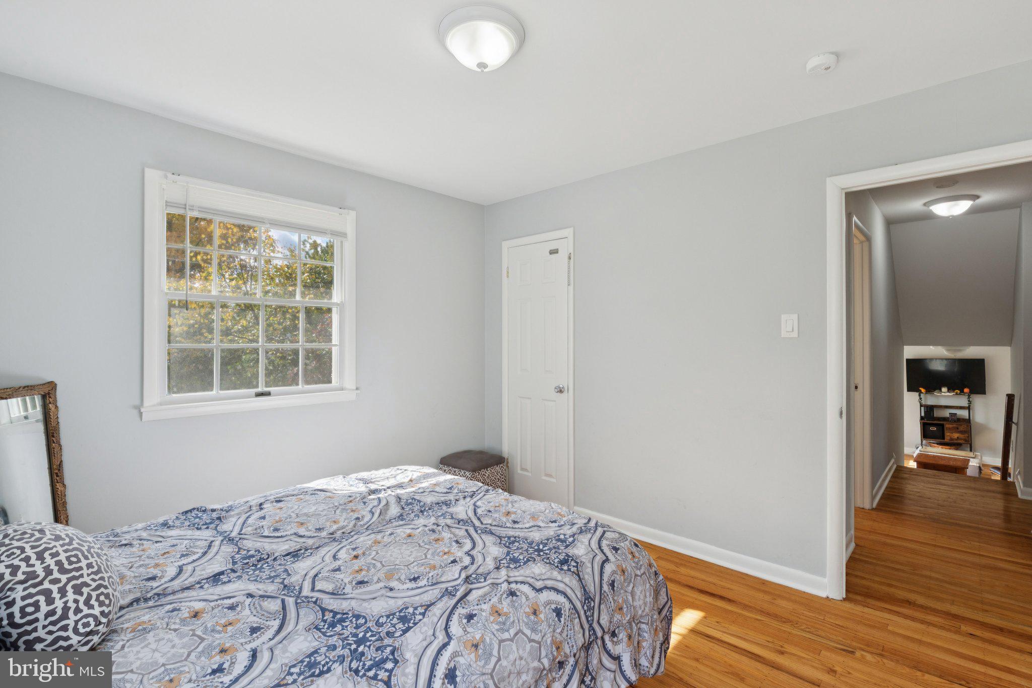 407 Yorkshire Road Cherry Hill, NJ 08034 - Photo 32 of 62 a bedroom with a bed and wooden floor