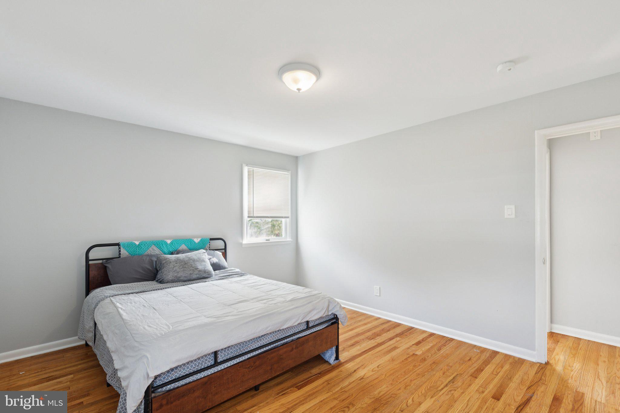 407 Yorkshire Road Cherry Hill, NJ 08034 - Photo 35 of 62 a bedroom with a bed and wooden floor