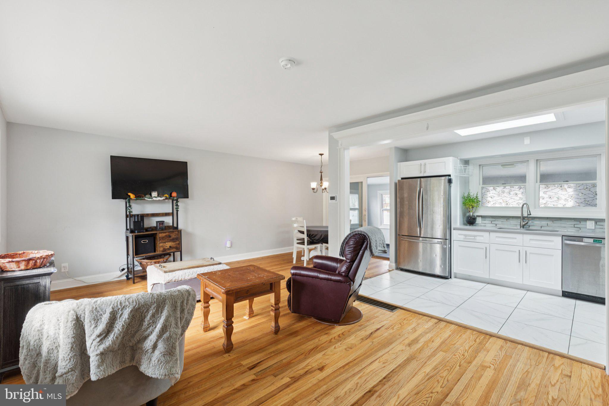 407 Yorkshire Road Cherry Hill, NJ 08034 - Photo 7 of 62 a living room with furniture a flat screen tv and kitchen view