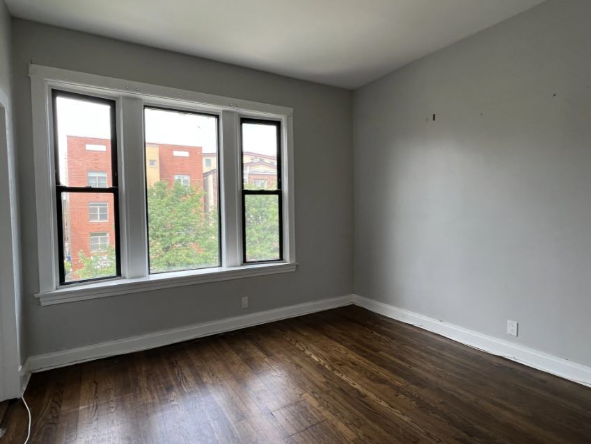 2131 West Division Street, Unit 3F Chicago, IL 60622 - Photo 2 of 5 a view of an empty room with wooden floor and a window