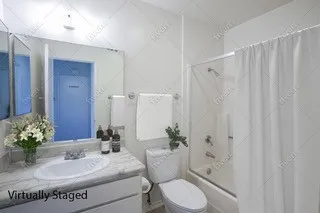 a bedroom with furniture and a potted plant