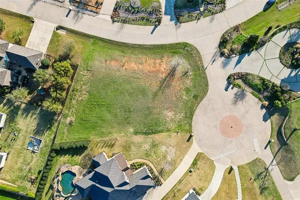 an aerial view of a swimming pool with a yard