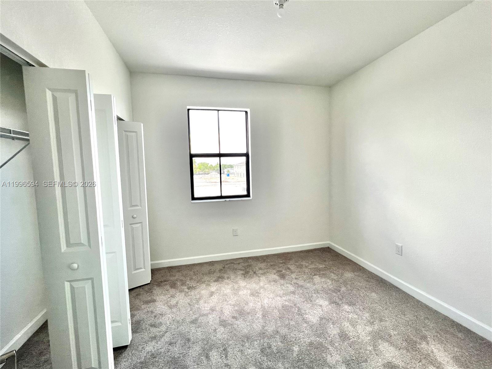 23373 Southwest 129th Path, Unit 23373 Homestead, FL 33032 - Photo 15 of 18 an empty room with a window