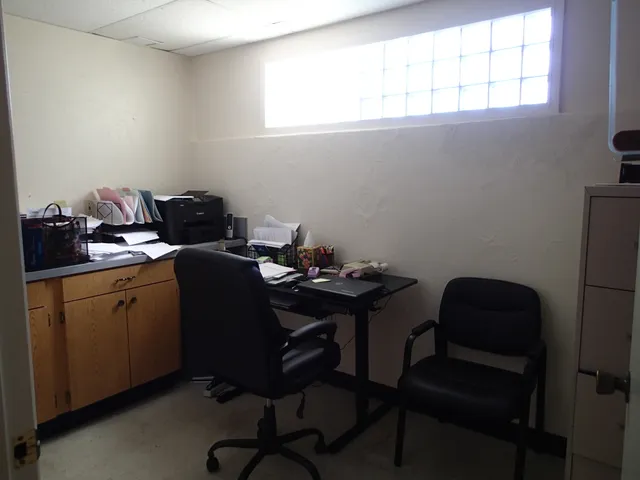 a kitchen with granite countertop a sink stove and cabinets
