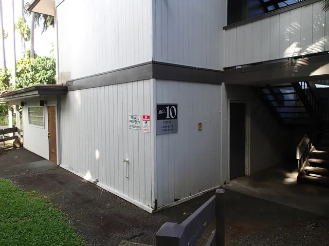 a view of a brick house with a yard