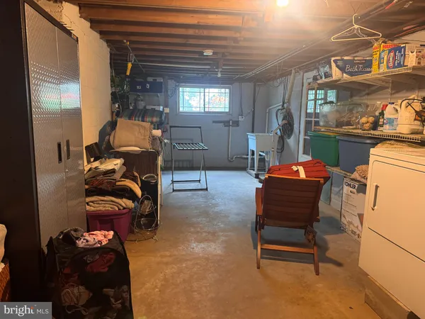 a room with furniture a ceiling fan and a window