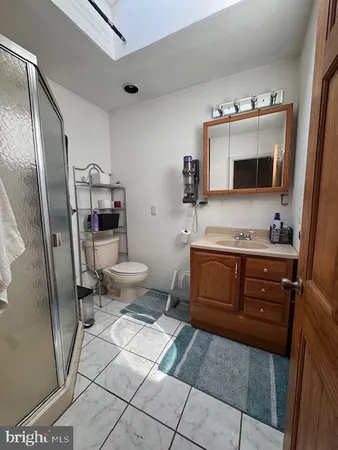 a bathroom with a sink toilet and mirror