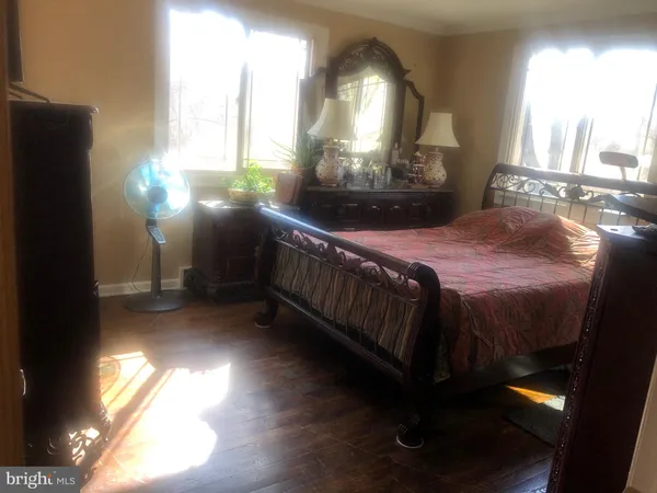 a bedroom with a bed next to a window