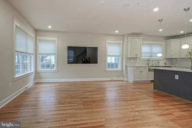 a view of kitchen with wooden floor and electronic appliances