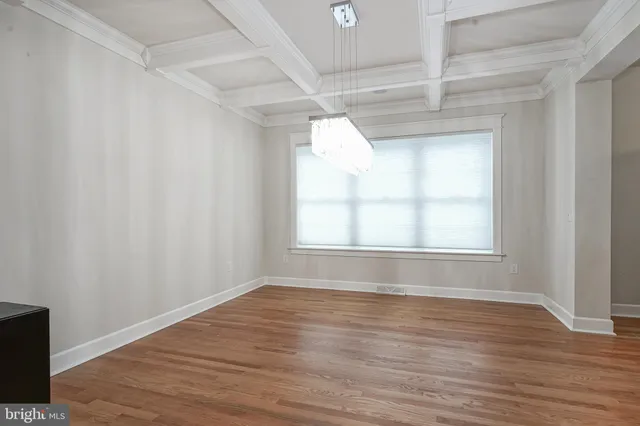 a view of wooden floor and windows in a room