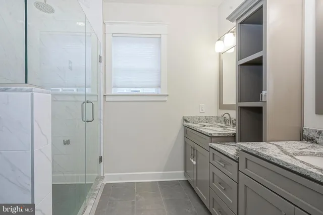 a bathroom with a granite countertop sink a vanity and a mirror