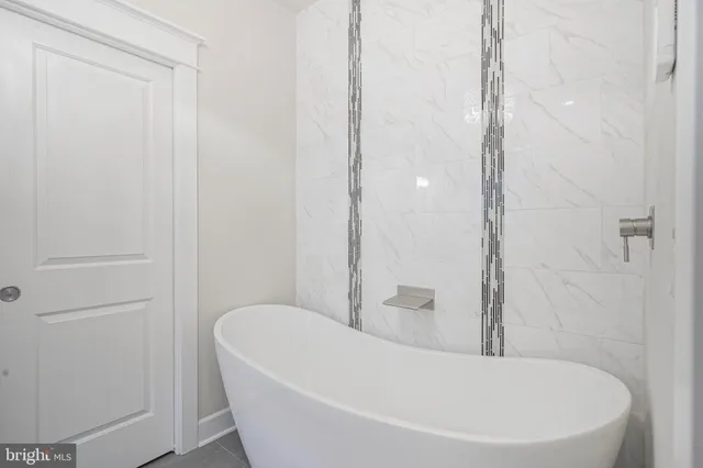 a white bath tub sitting in a bathroom