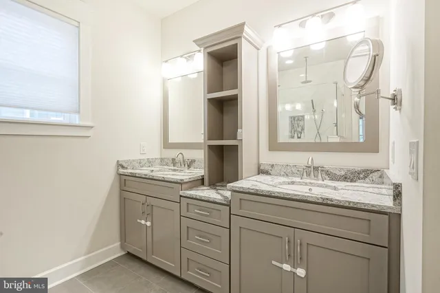 a bathroom with a double vanity sink mirror and