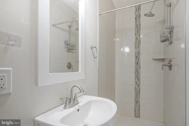 a bathroom with a shower and sink
