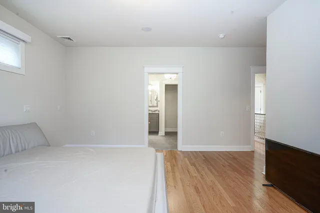 an empty room with wooden floor and closet