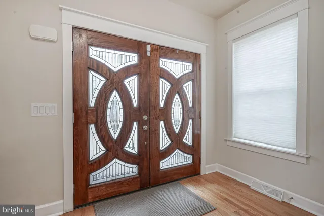 a view of an entryway with wooden floor