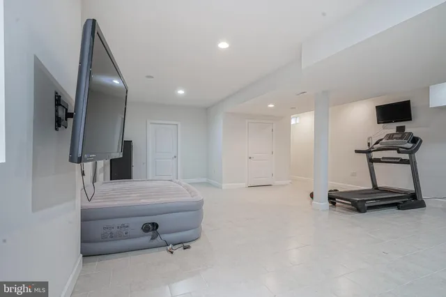 a bedroom with a bed and gym equipment