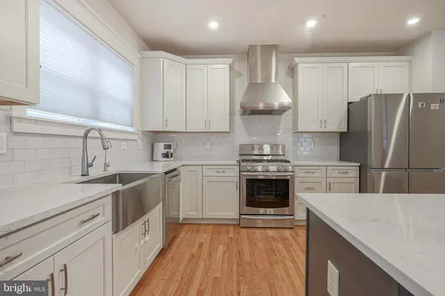 a kitchen with a sink cabinets and stainless steel appliances