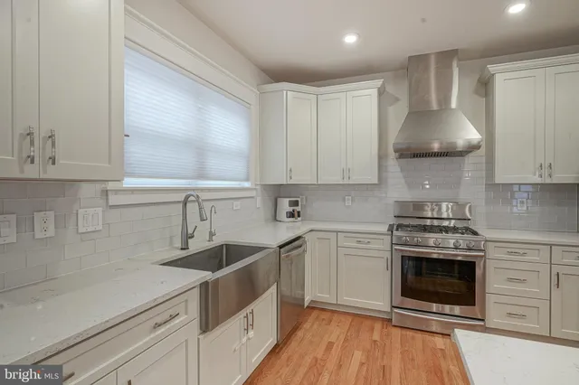 a kitchen with a sink stove and cabinets