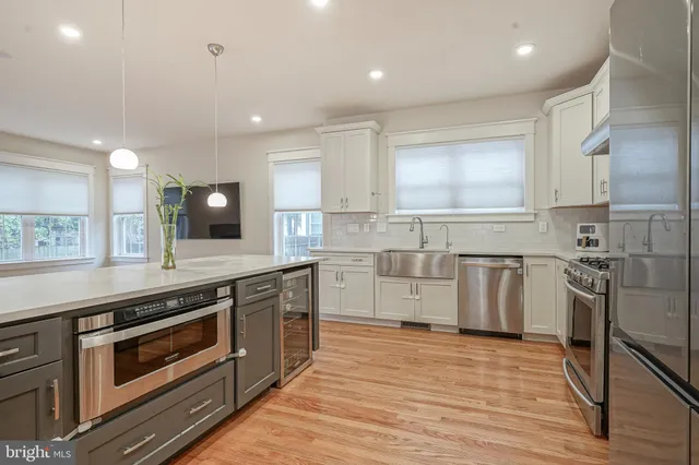 a kitchen with a sink stove and cabinets
