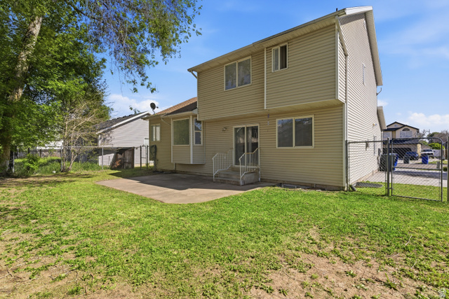 134 West 475 South Ogden, UT 84404 - Photo 24 of 27 Rear view of property featuring a gate, a fenced backyard, and a patio